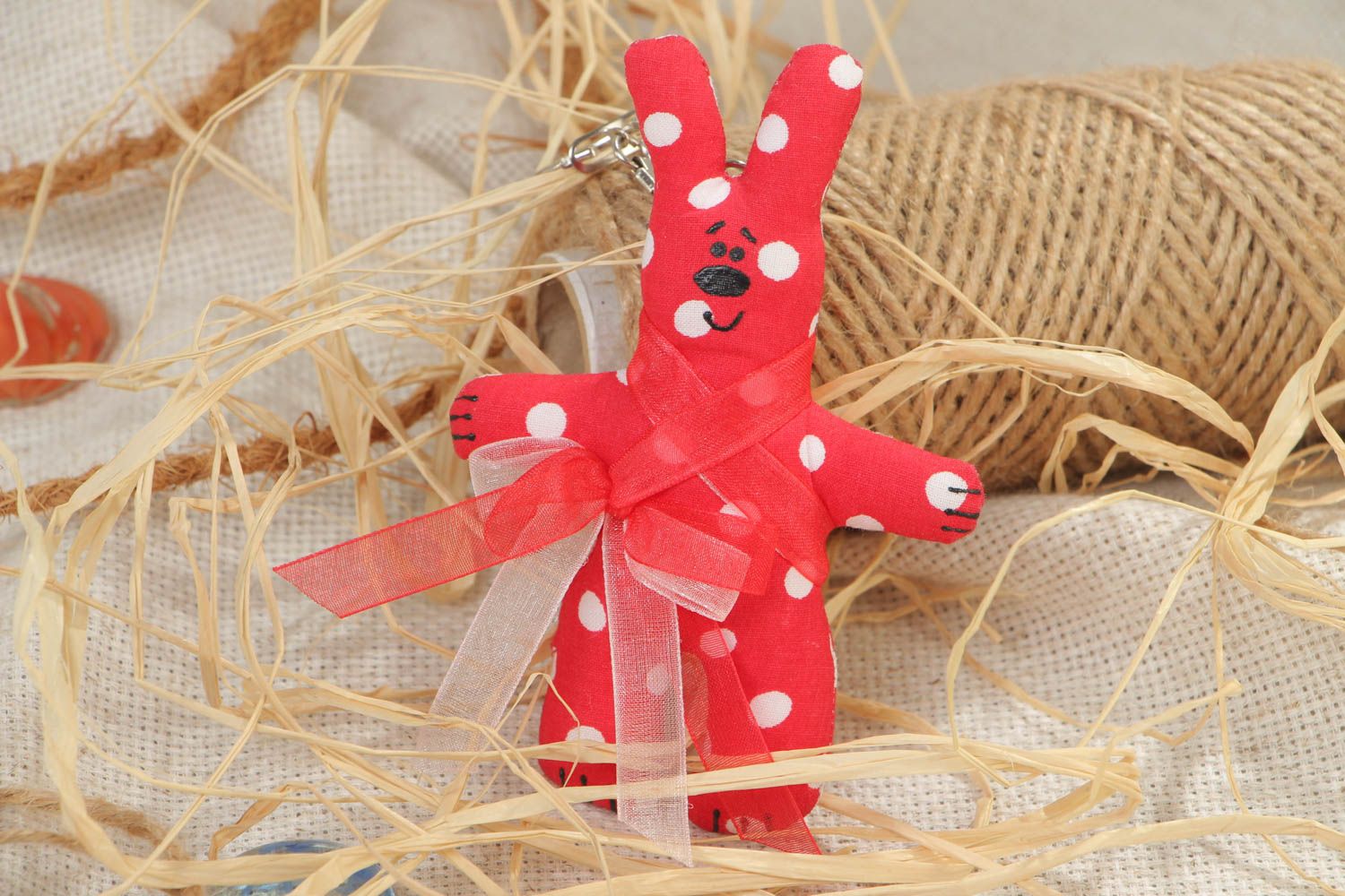 Handmade soft toy keychain sewn of cotton fabric in the shape of red rabbit photo 1