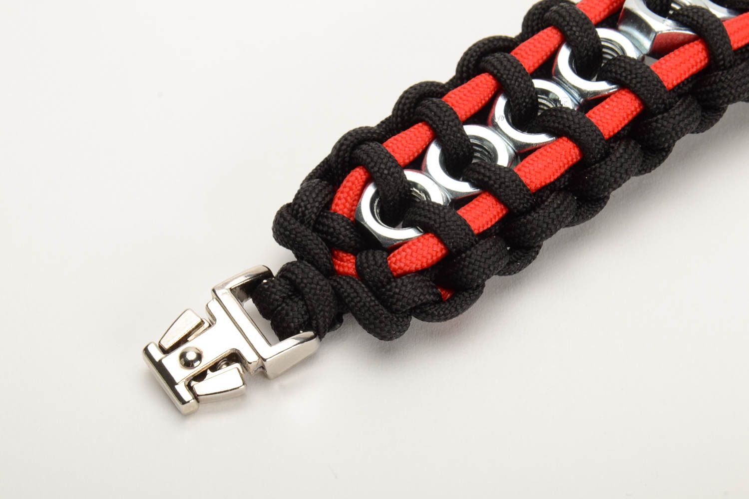 Unusual black and red woven paracord bracelet with metal nuts and fastener handmade photo 2