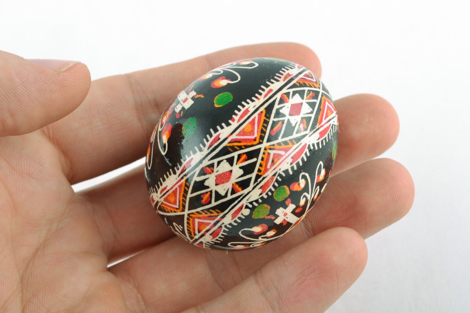 Handmade Easter egg with cross-shaped ornament painted with wax and aniline dyes photo 2