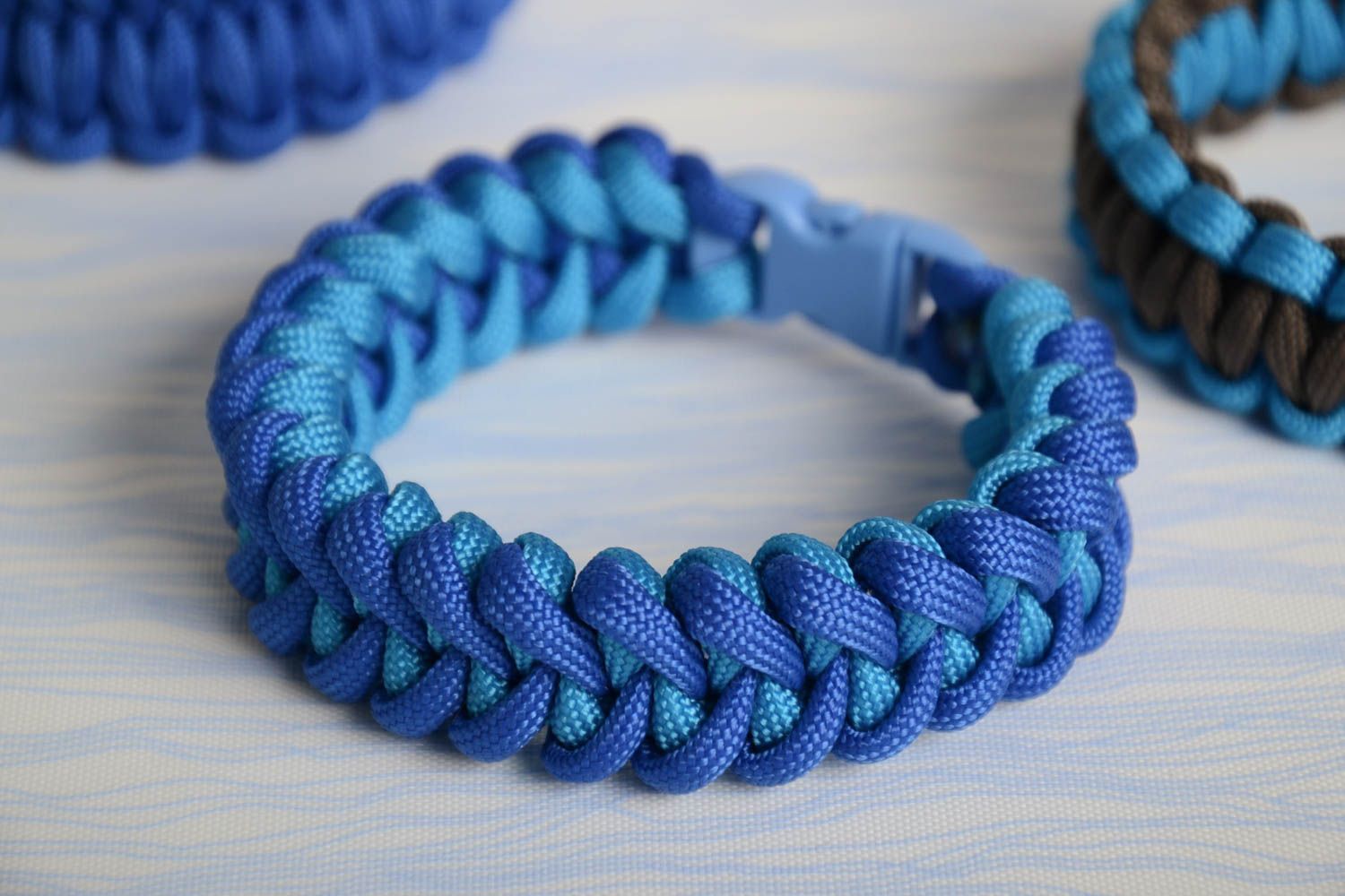 Handmade wrist survival bracelet woven of blue parachute cord with plastic fastener photo 1
