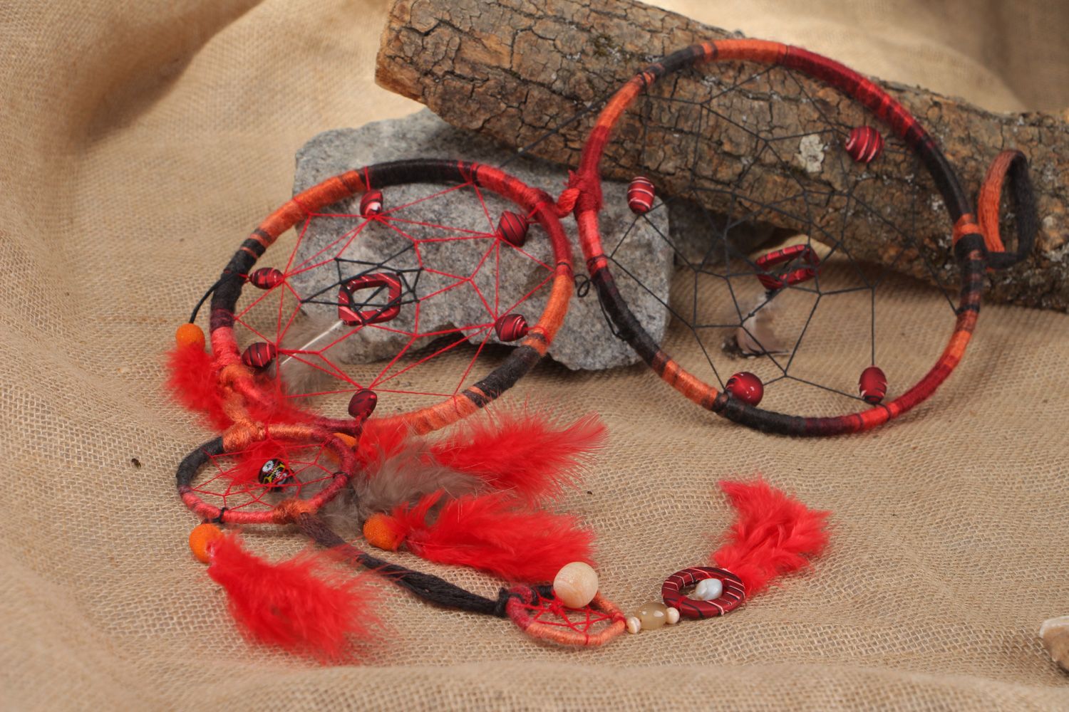 Long red homemade dreamcatcher wall hanging with natural stones and feathers photo 1
