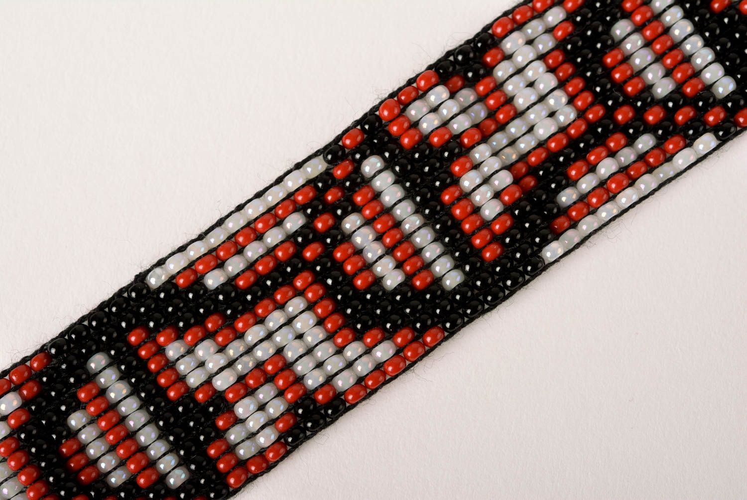 Handmade geometrical ornament beaded bracelet in black, red, gray color photo 3