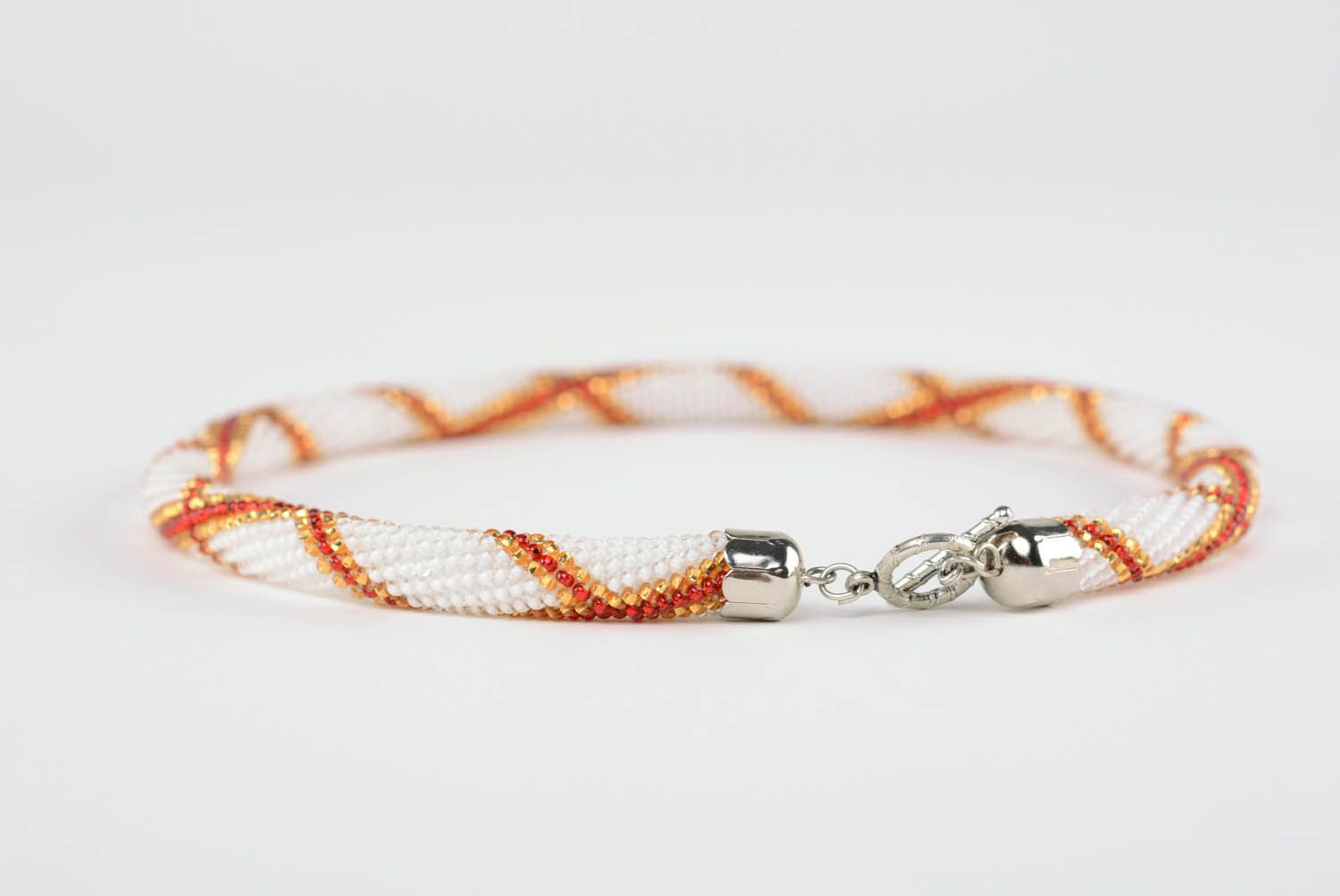 Handmade beaded cord necklace in white, red, and orange beads photo 1