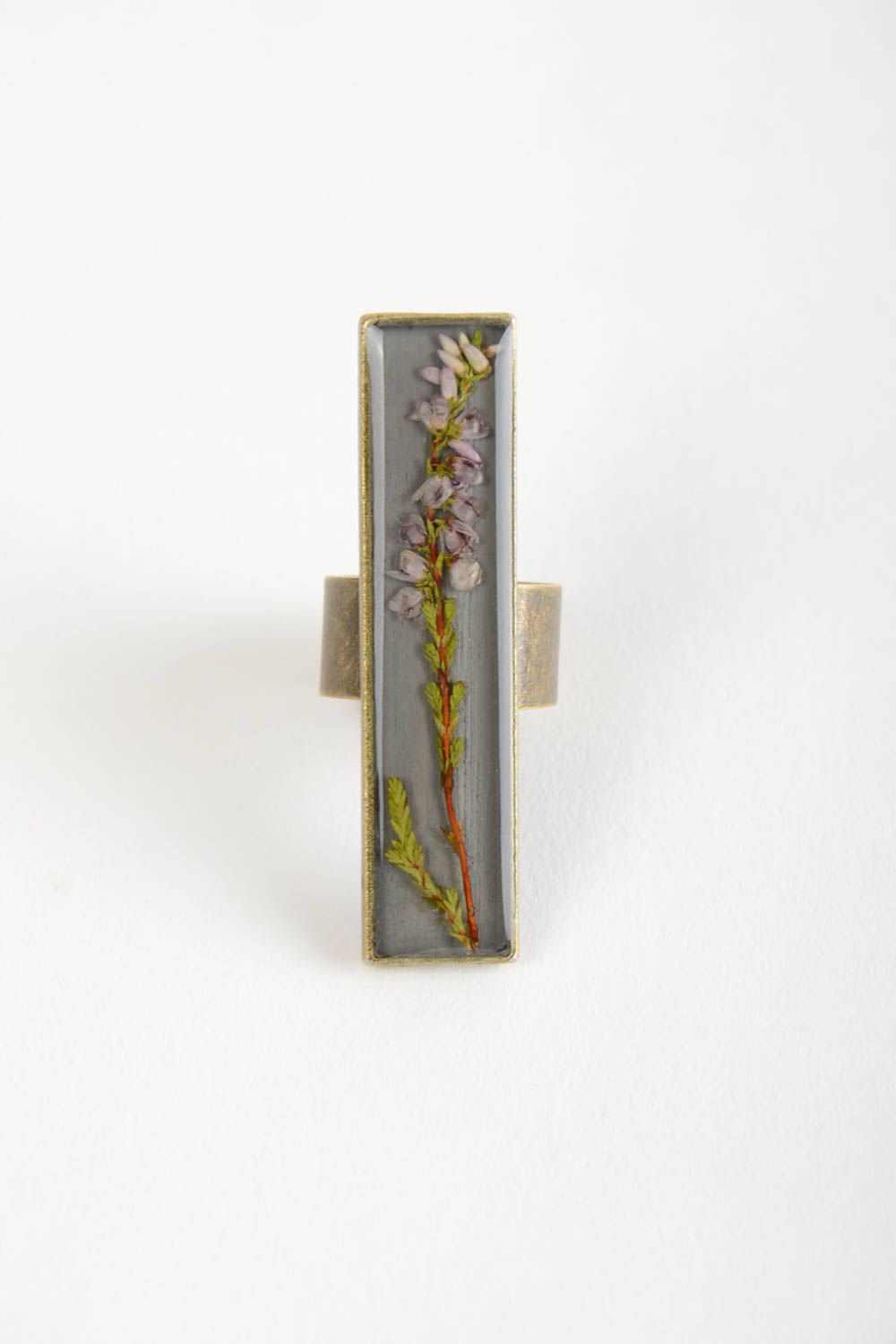 Beautiful designer women's ring with dried flowers coated with epoxy resin photo 4