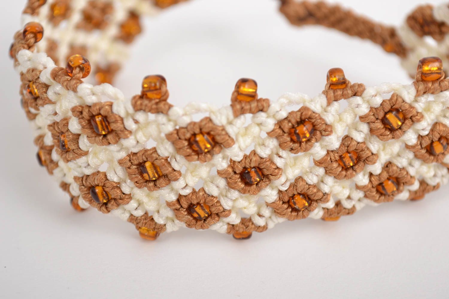 Handmade designer macrame wrist bracelet woven of synthetic threads with beads photo 1