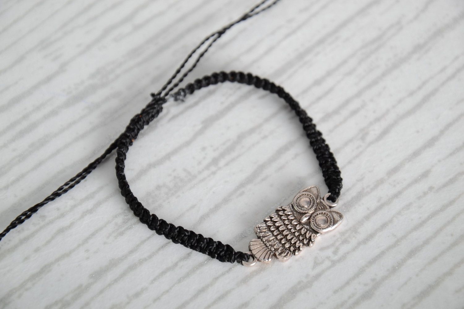 Handmade black woven capron thread wrist bracelet with metal charm in the shape of owl photo 1