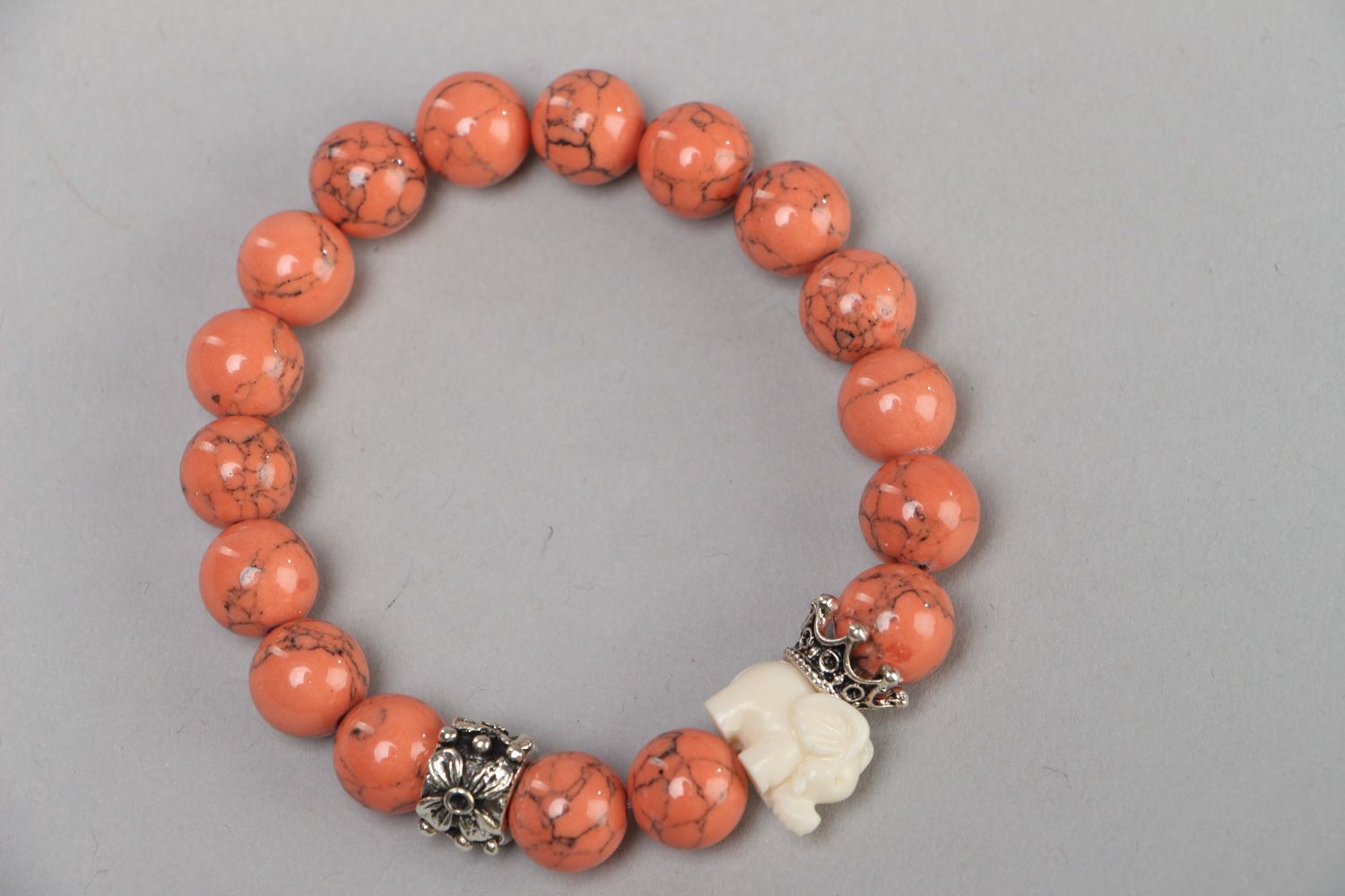 Handmade stretch wrist bracelet with natural coral beads and elephant figurine photo 2