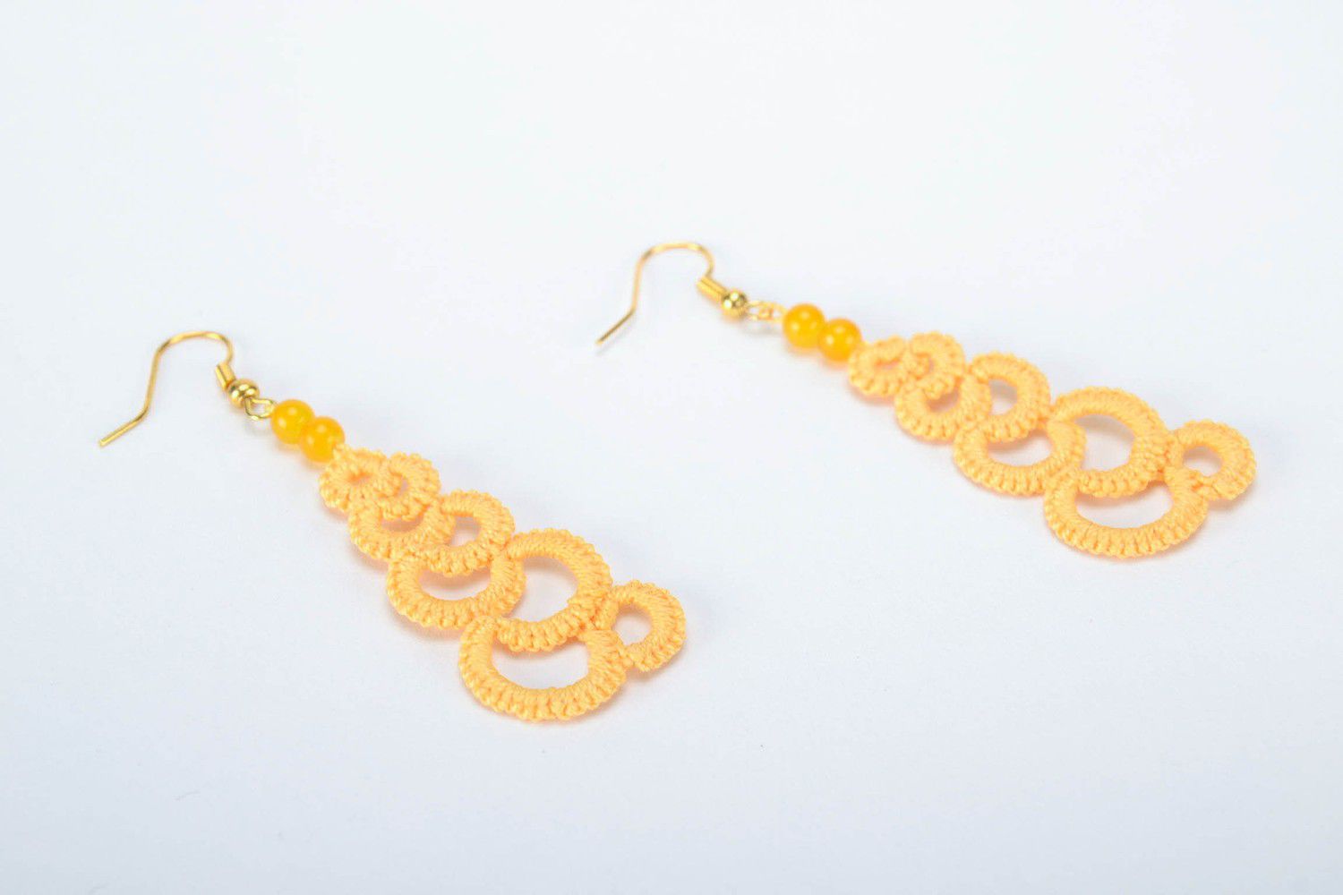 Orange earrings made from woven lace photo 2