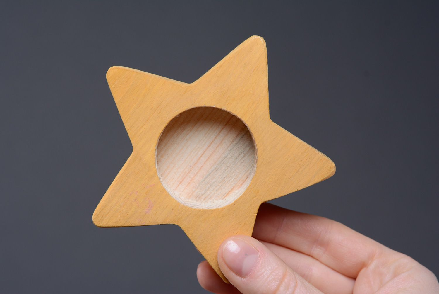 Yellow wooden candlestick in the shape of star photo 4