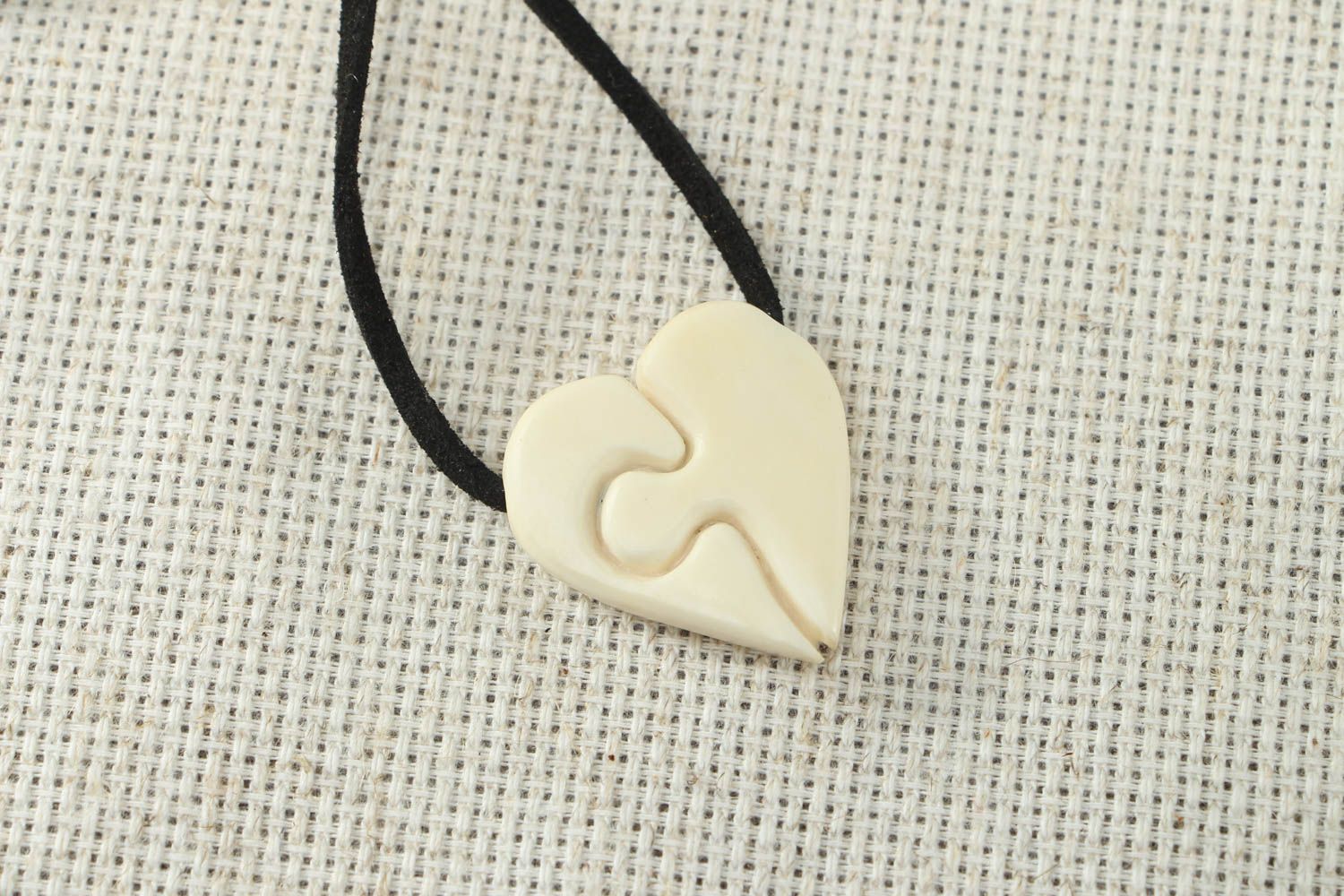 Heart shaped pendant carved of cow bone photo 1