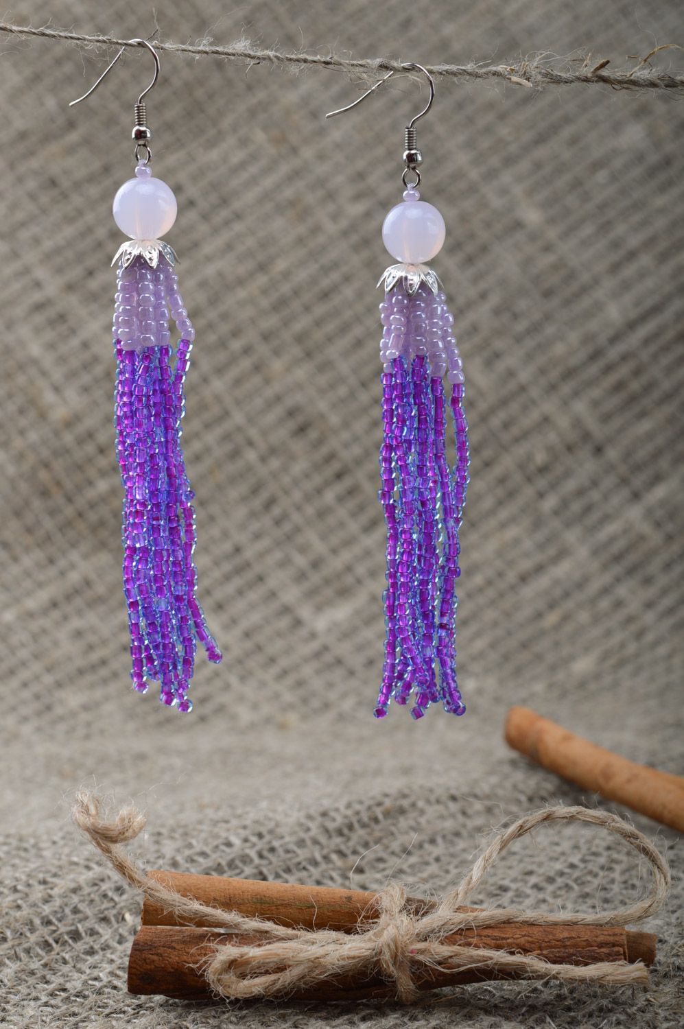 Handmade women's lilac long beaded earrings with charms  photo 1