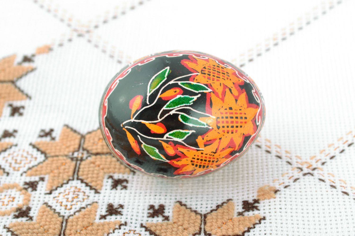 Handmade Easter egg with floral ornament on black background painted with hot wax photo 1