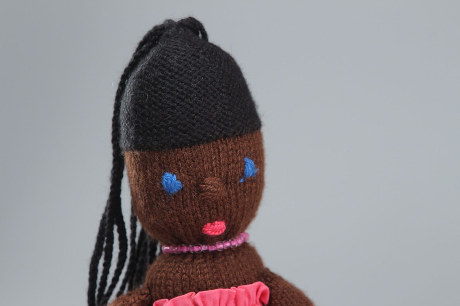 Handmade soft toy knitted of acrylic threads Mulatto in pink dress for little girl photo 2