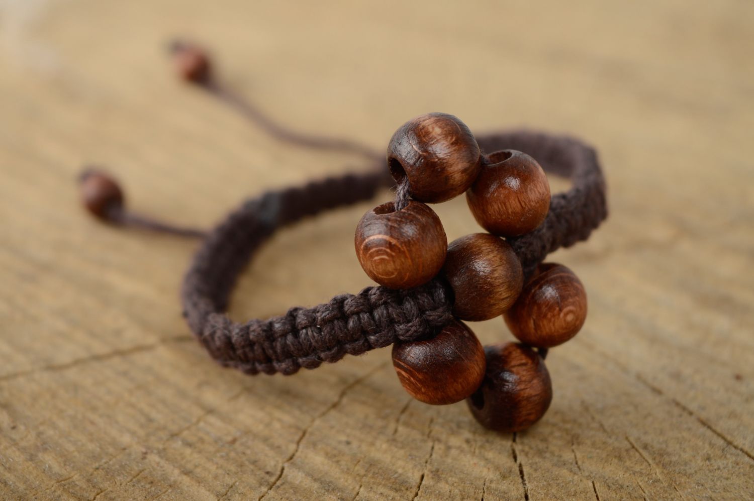 Unusual macrame bracelet of brown color with wooden beads photo 1