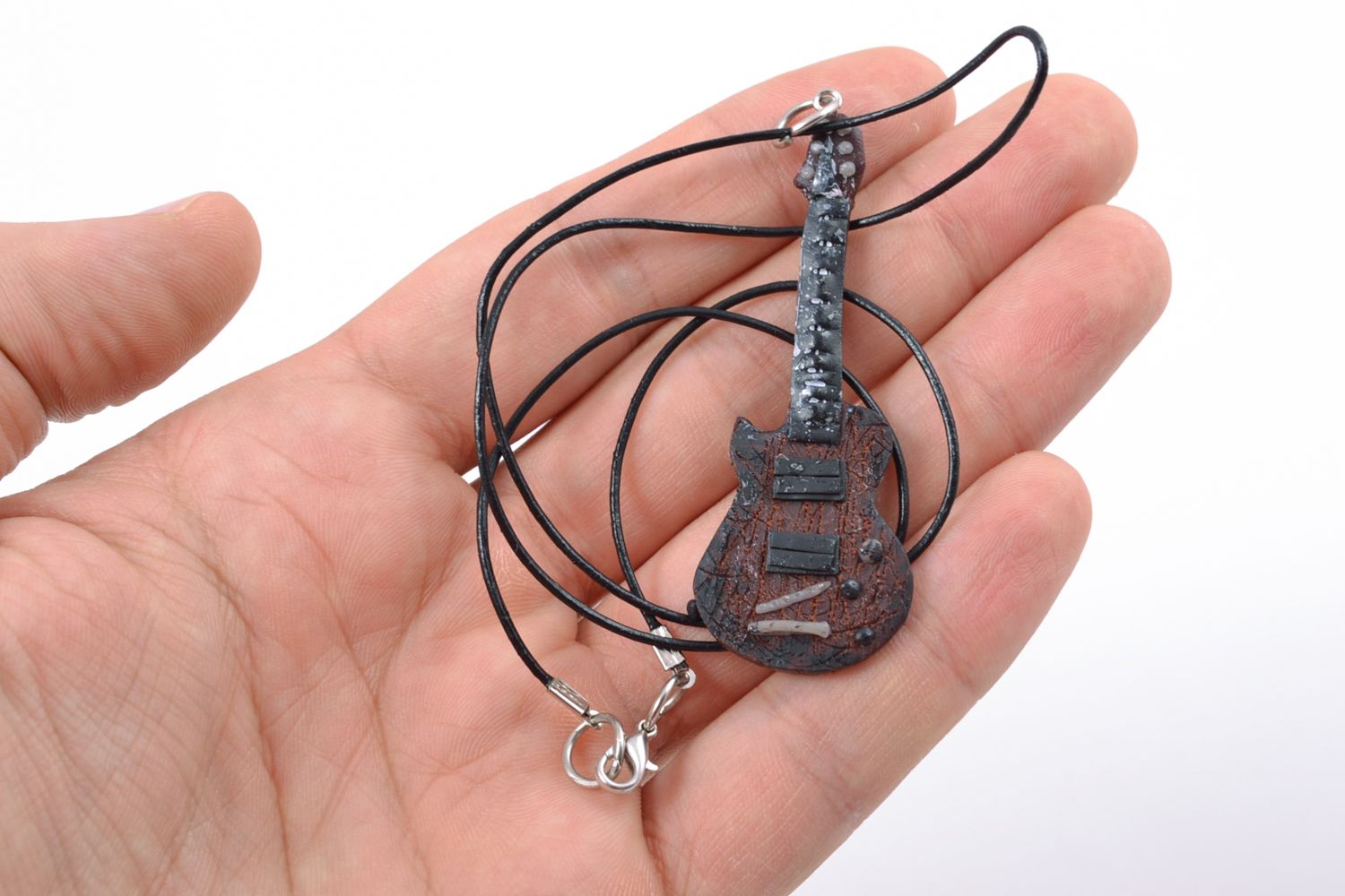 Polymer clay pendant in the shape of guitar on cord photo 1