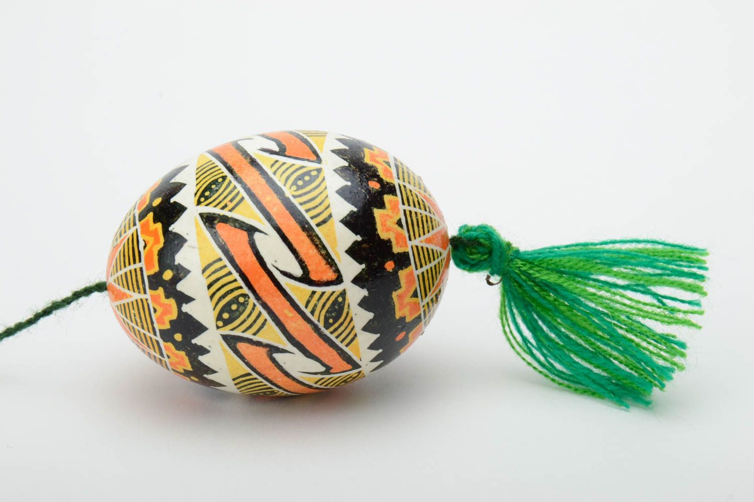 Handmade traditional wax painted colorful Easter egg with green tassel photo 3