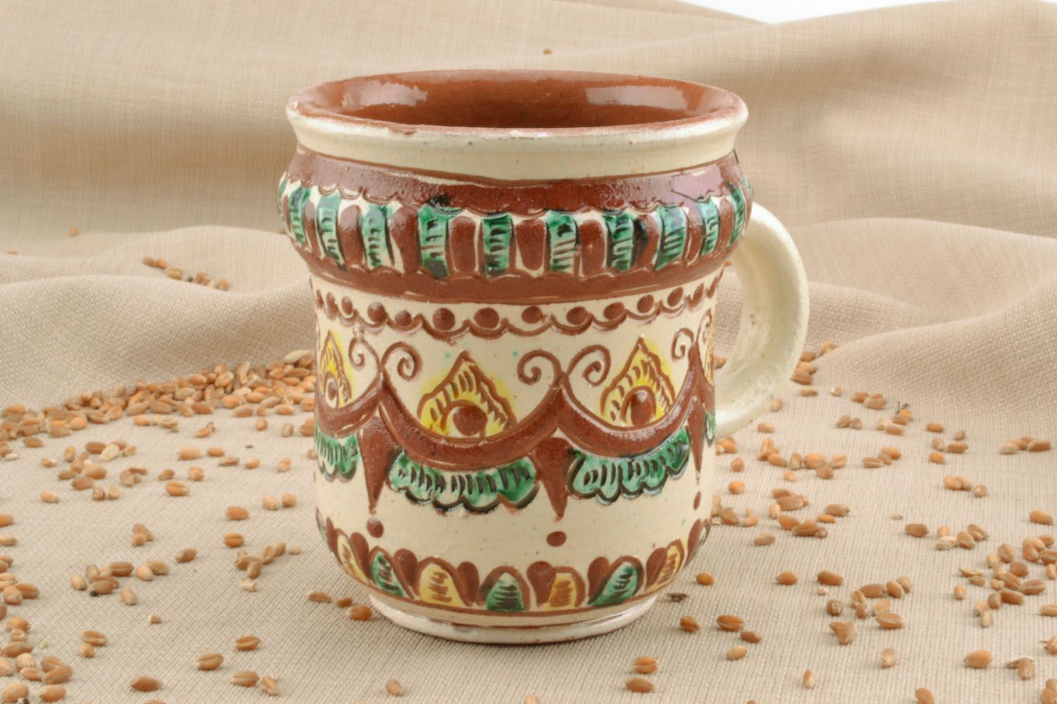 Decorative cup with ethnic green, cherry, beige colors' and a handle photo 1