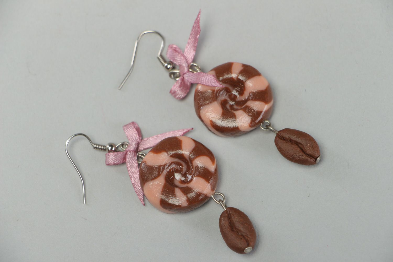 Handmade round dangle earrings made of plastic with satin bows in brown color photo 1