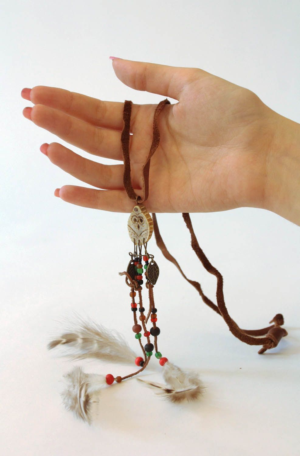 Pendant made of deer antler and feathers photo 1