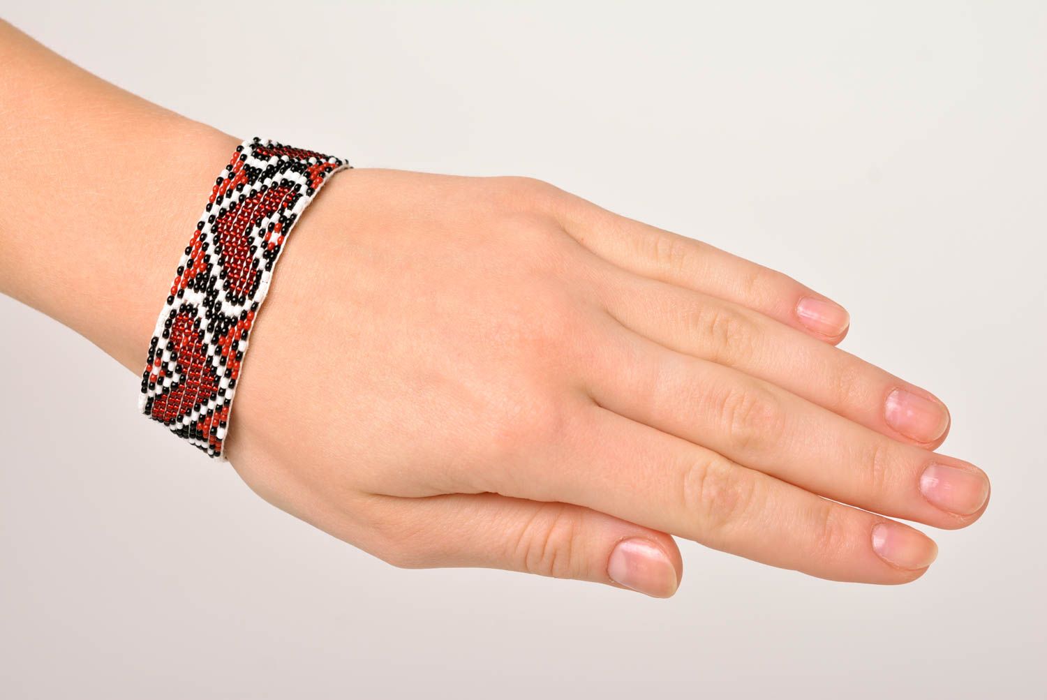Handmade beaded bracelet with Ukrainian style ornament in red, black, and white color photo 2