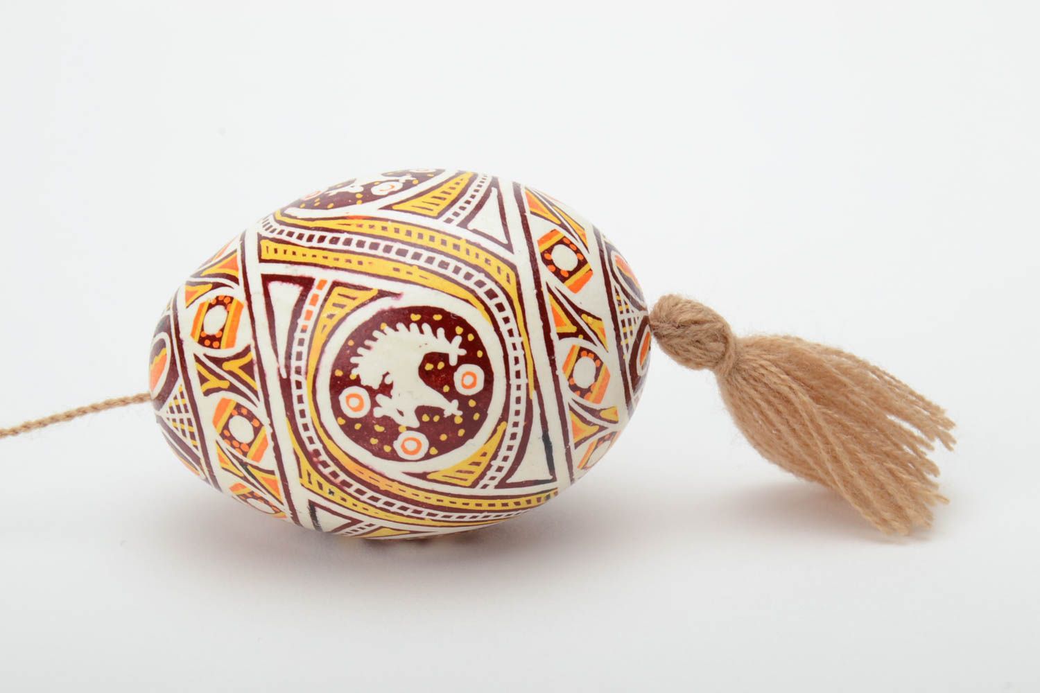 Homemade painted Easter egg with tassel and patterns created using waxing technique photo 3