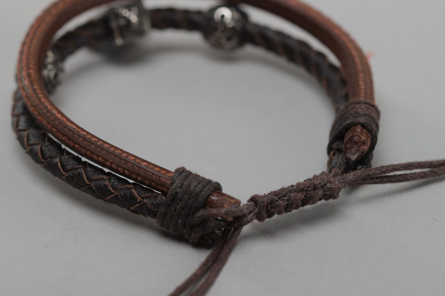 Handmade women's wrist bracelet woven of genuine leather of brown color photo 4