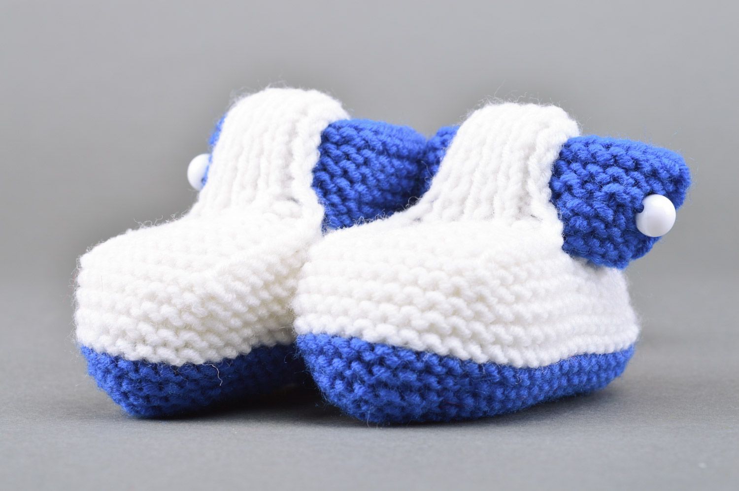 Small handmade knitted baby booties of white and blue colors for boy photo 5