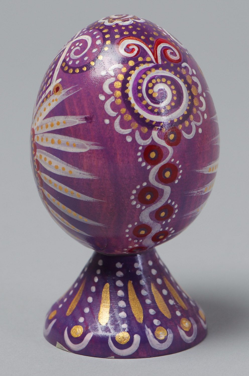 Handmade painted wooden Easter egg of lilac color in ethnic style photo 2