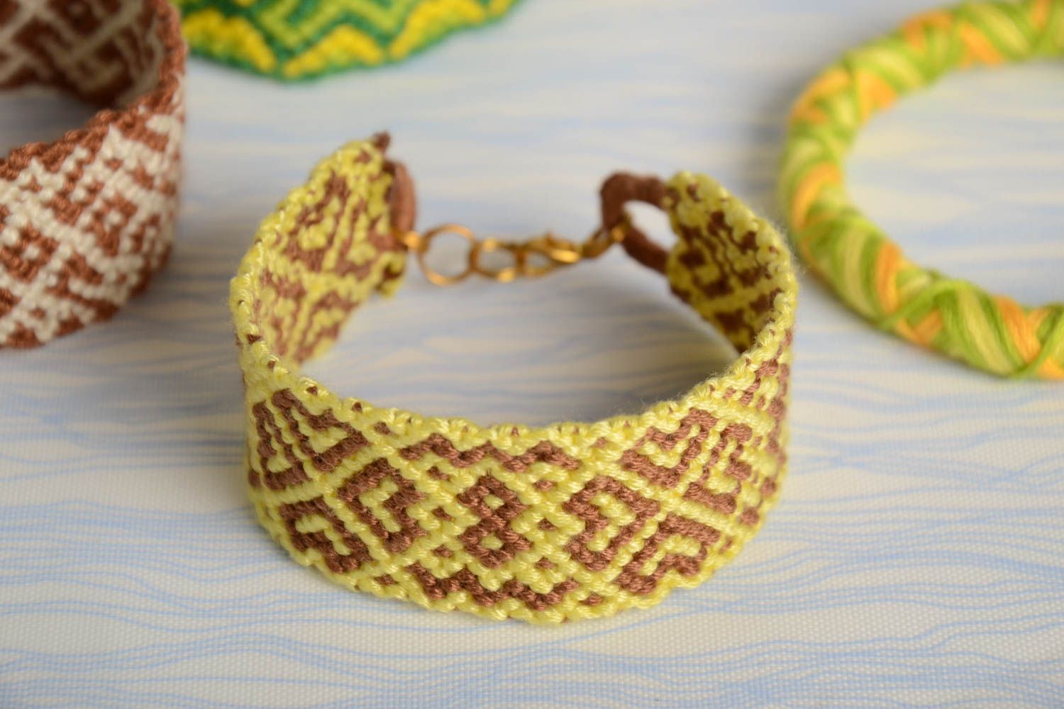 Handmade colored woven wide friendship bracelet made of floss threads yellow with beige photo 1