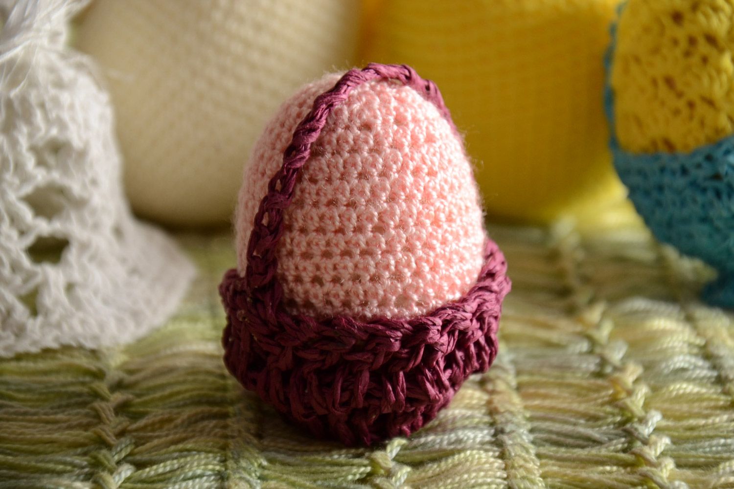Handmade decorative crochet Easter egg of pink color in basket photo 1