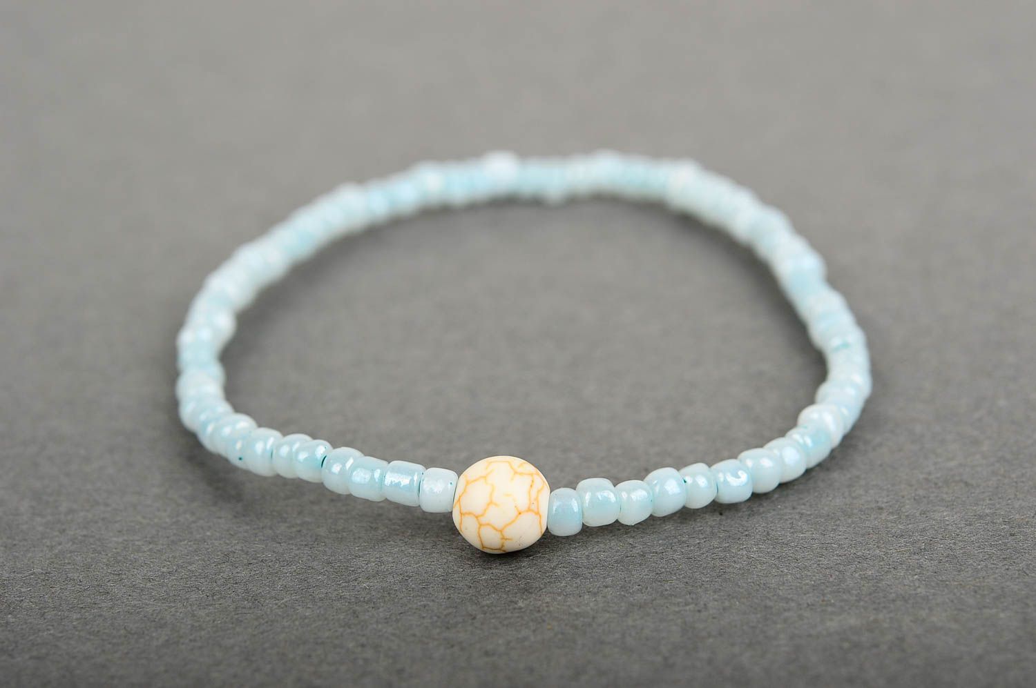 Handmade pale blue beaded stretchy wrist bracelet with beige ball shape centerpiece photo 3