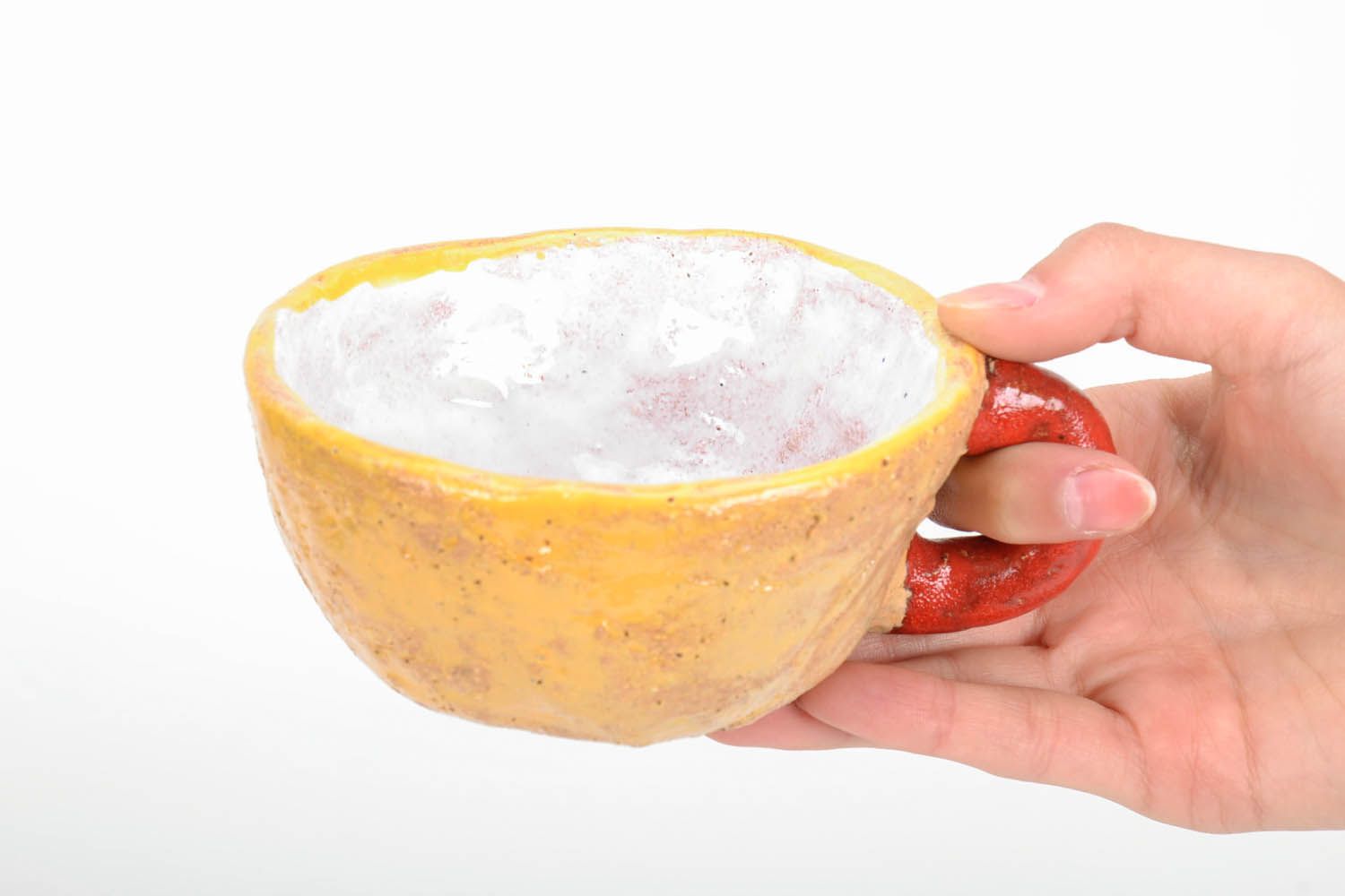 Hand-molded clay glazed cup in yellow and red colors. Wide cup with white inside glaze. photo 5