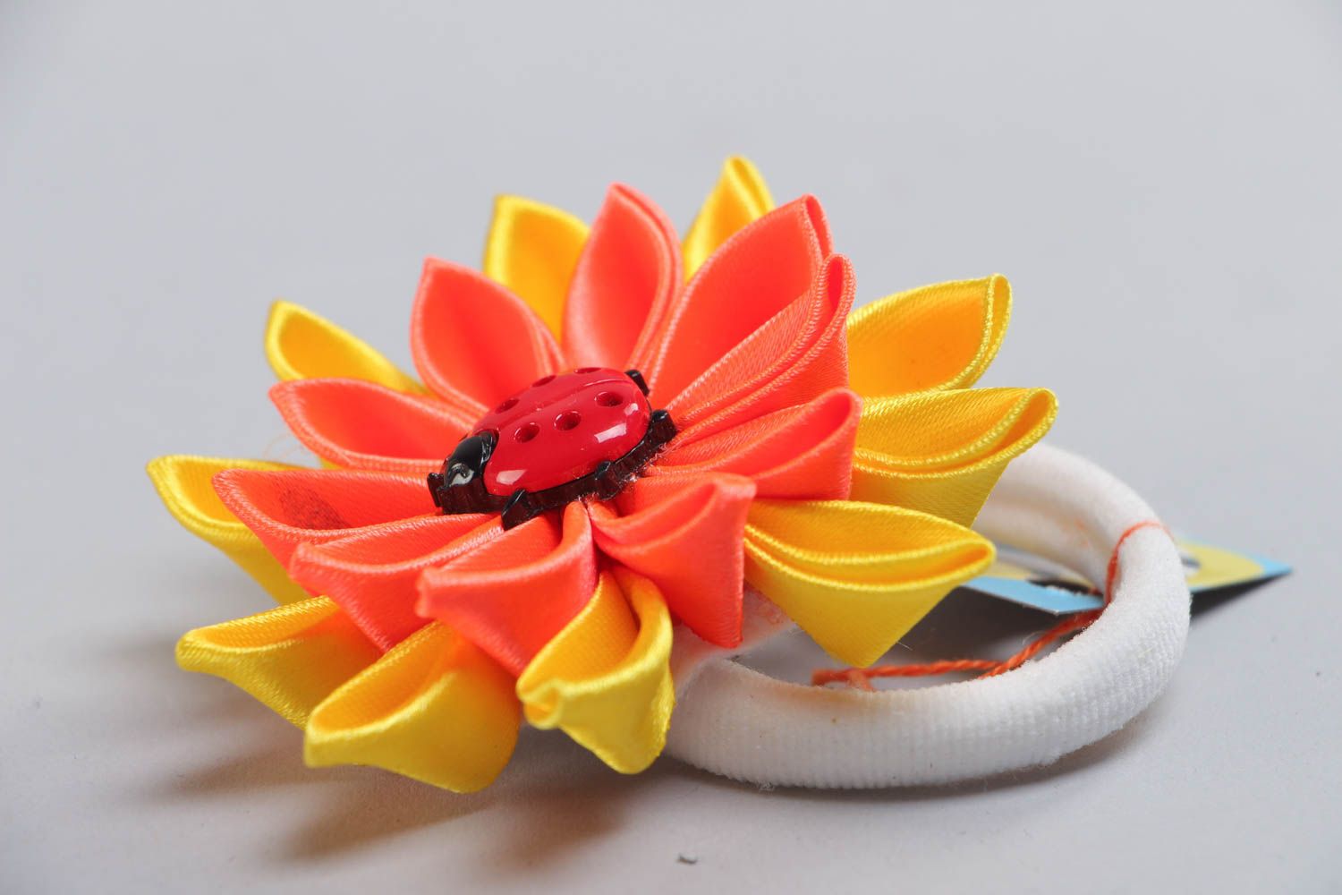 Handmade scrunchy with bright yellow and orange large flower made using kanzashi technique photo 3
