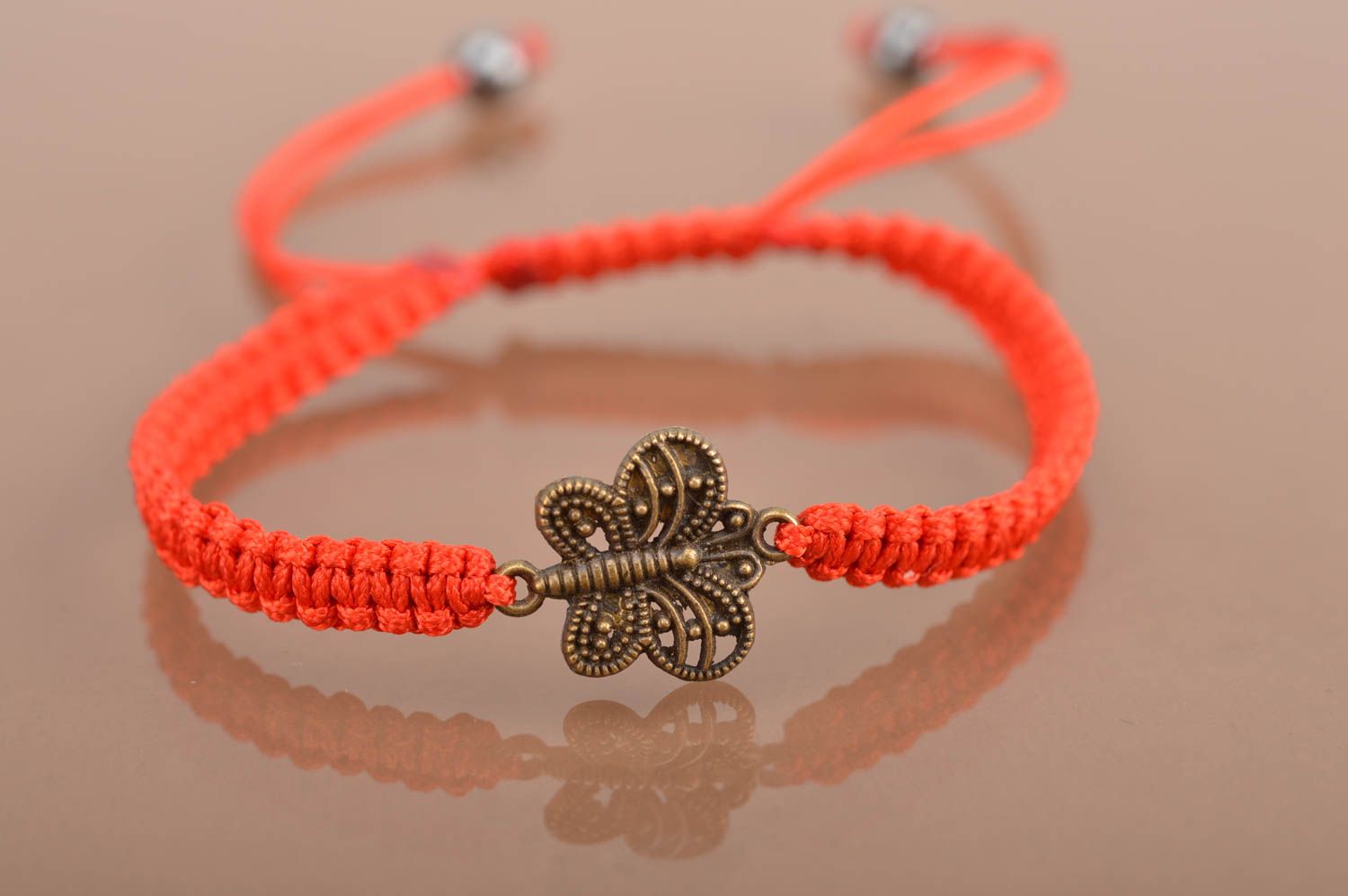 Handmade stylish red woven wrist bracelet made of threads with butterfly photo 2