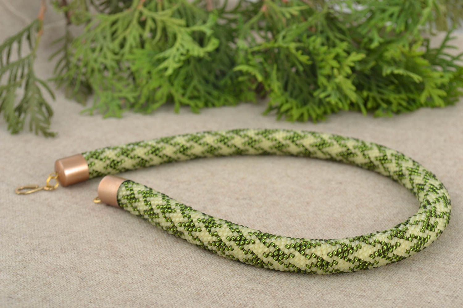 Beige and green handmade beaded cord necklace with geometric pattern photo 1