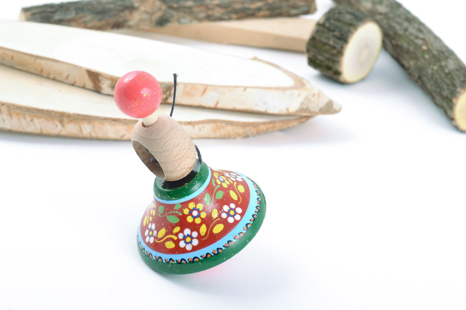Small handmade decorative beautiful wooden spinning top with painted ornaments photo 1