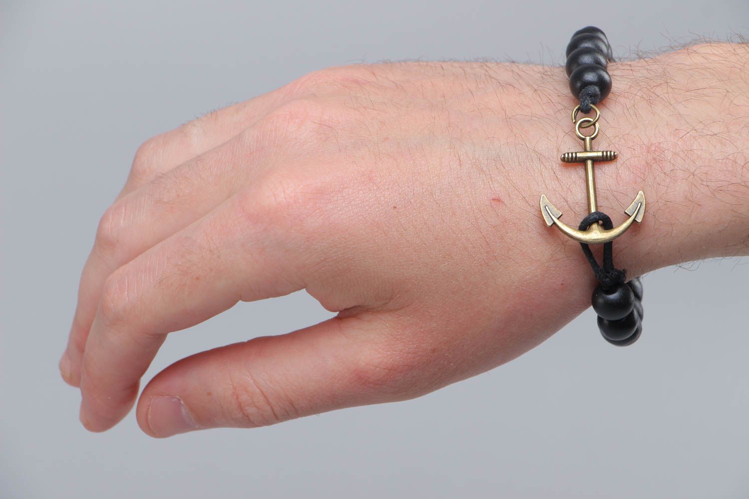 Handmade stylish black bracelet made of wooden beads with metal anchor photo 5
