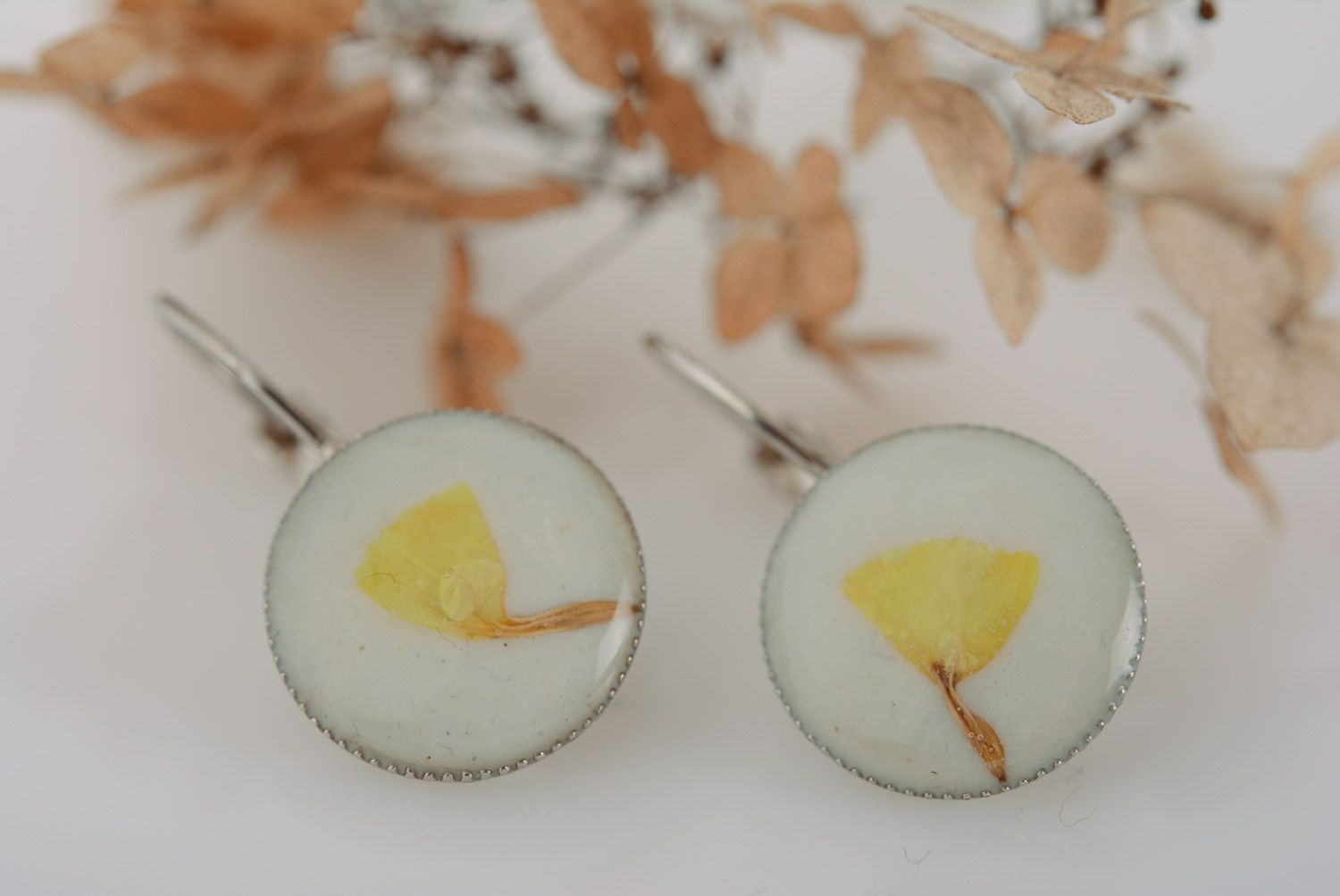 Handmade gentle white and yellow round earrings with dried flowers coated with epoxy photo 1