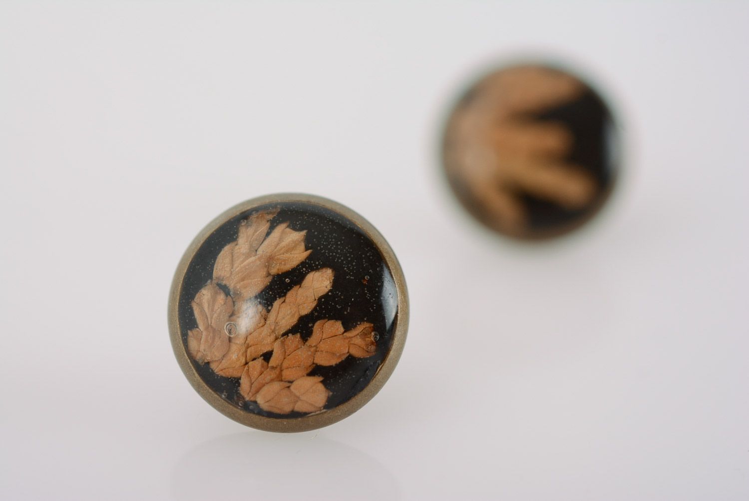 Small round homemade black stud earrings with dried flower in epoxy resin photo 4