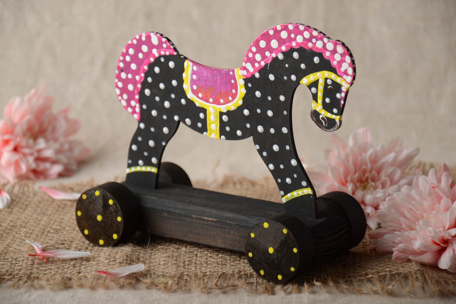 Black and white handmade children's painted wooden wheeled toy horse photo 1