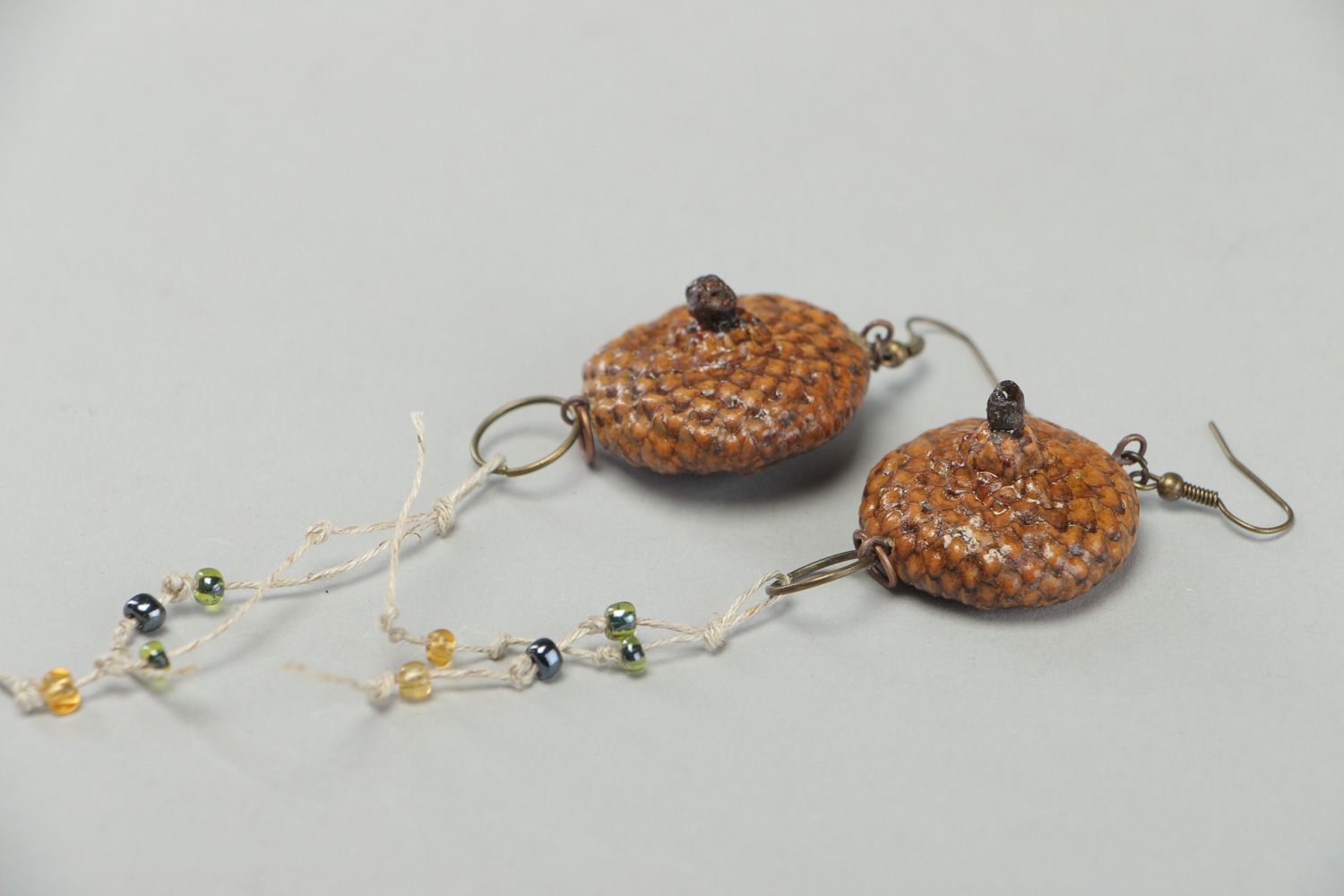 Handmade dangle earrings made of natural materials coated with epoxy resin photo 3