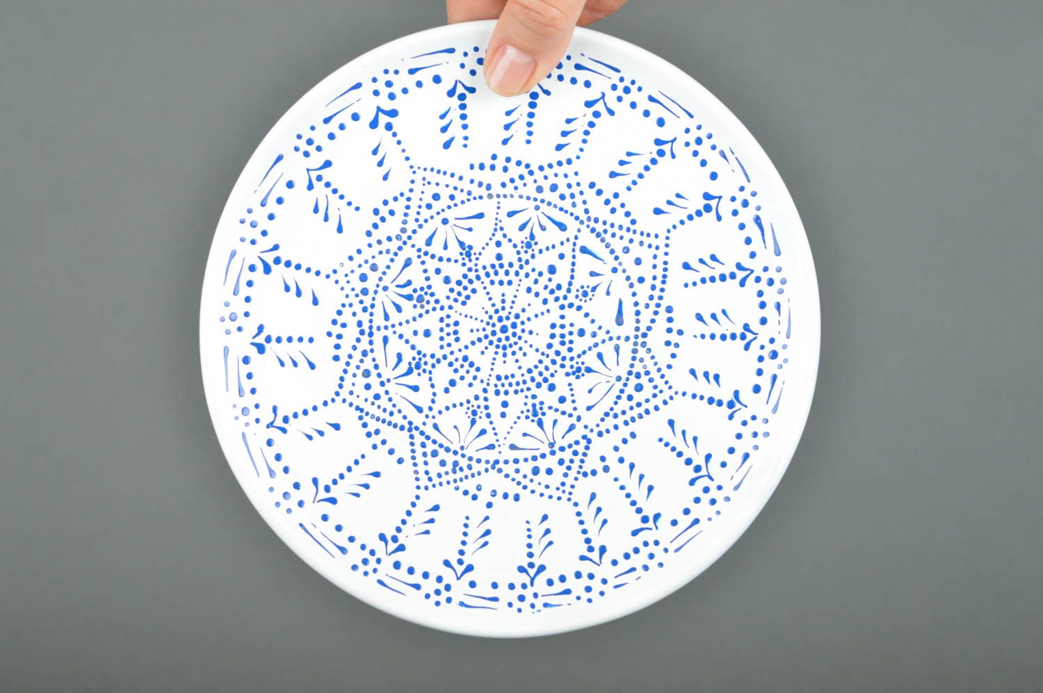 Decorative white with blue ceramic plate with acrylic paints ornament  photo 2