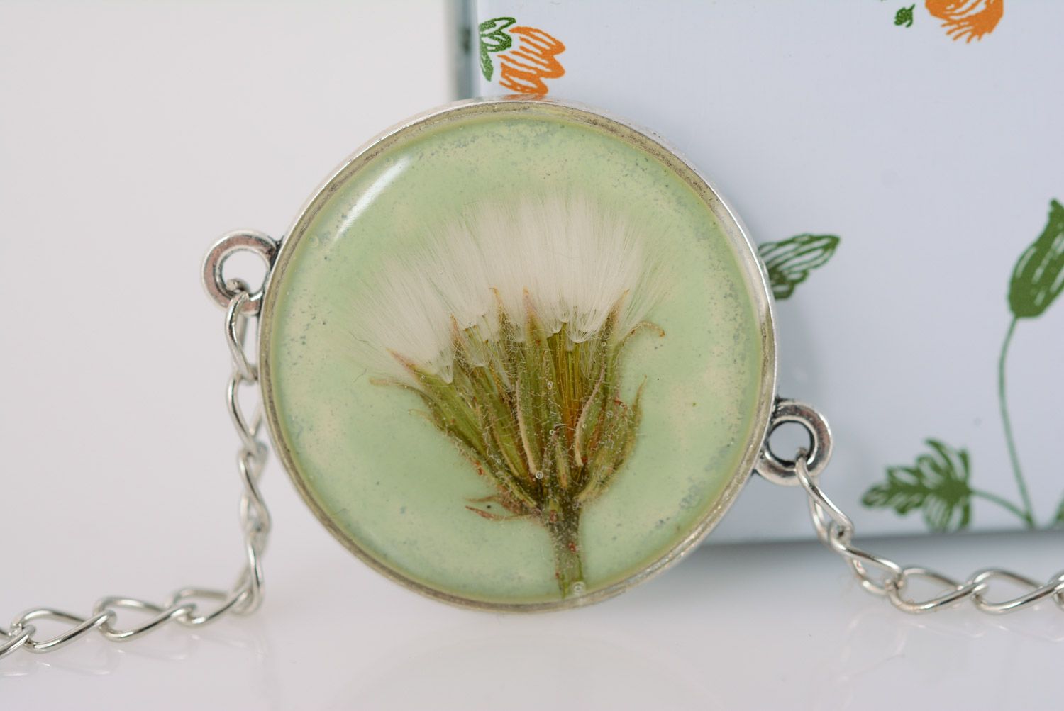 Handmade round transparent pendant with flower in epoxy resin on long metal chain photo 1