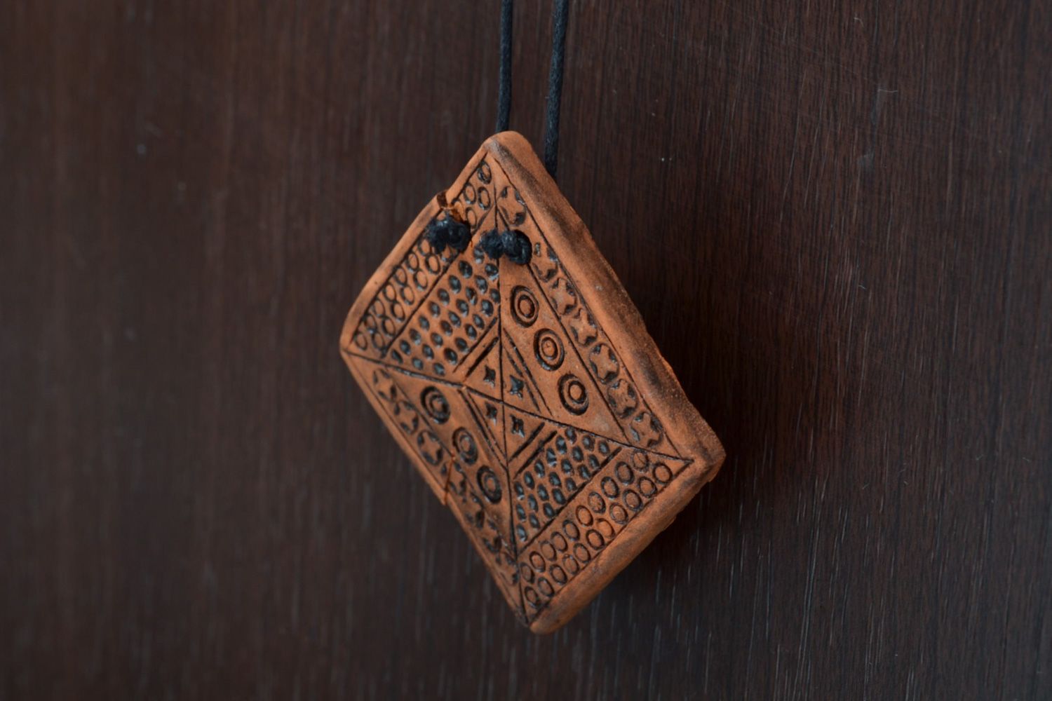 Handmade ceramic pendant with relief ornament in ethnic style and long cord  photo 1