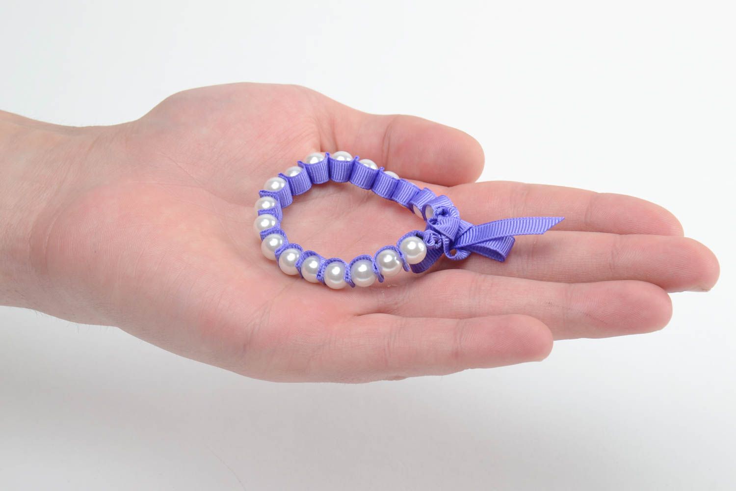 Handmade thin wrist bracelet with plastic pearl like beads and violet rep ribbon photo 5