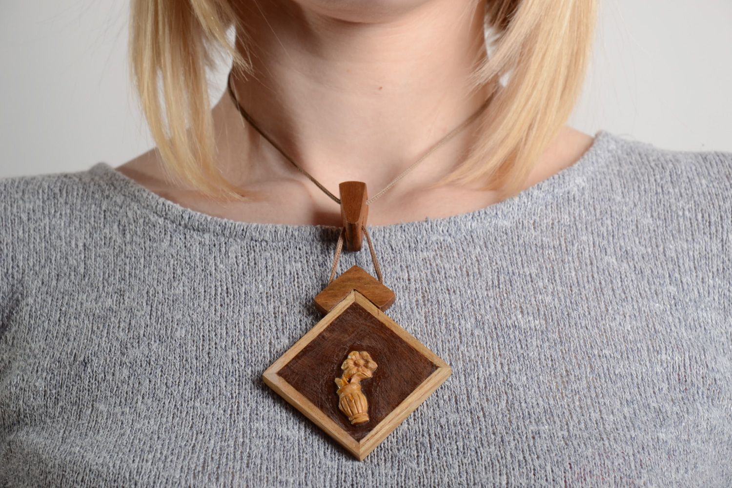 Handmade neck pendant carved of wood and decorated with inlay on synthetic cord photo 2