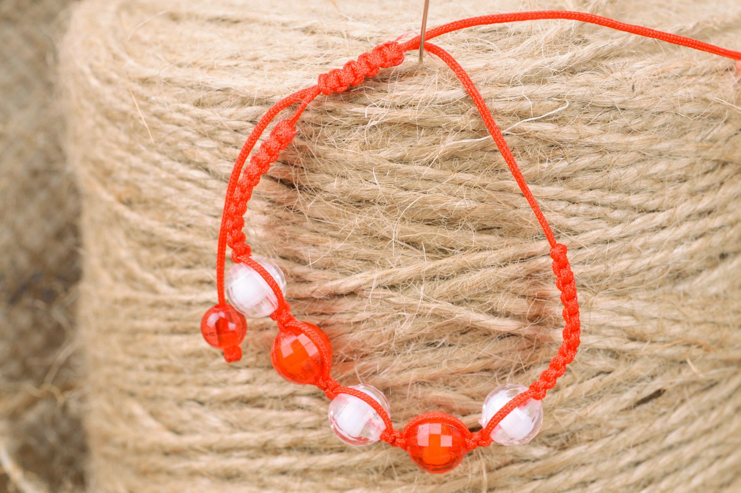 Beautiful bright handmade children's bracelet woven of threads and beads photo 1