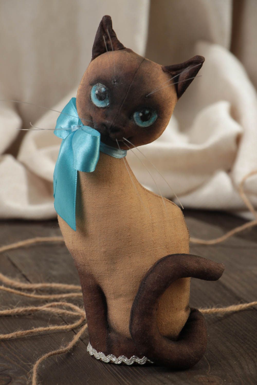 Handmade designer soft toy sewn of primed fabric beautiful cat with blue bow photo 1