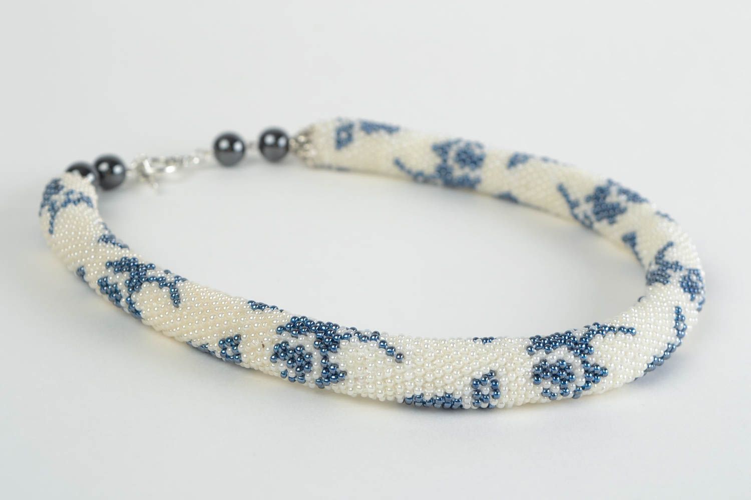 Beautiful handmade beaded cord necklace white with blue patterns photo 4