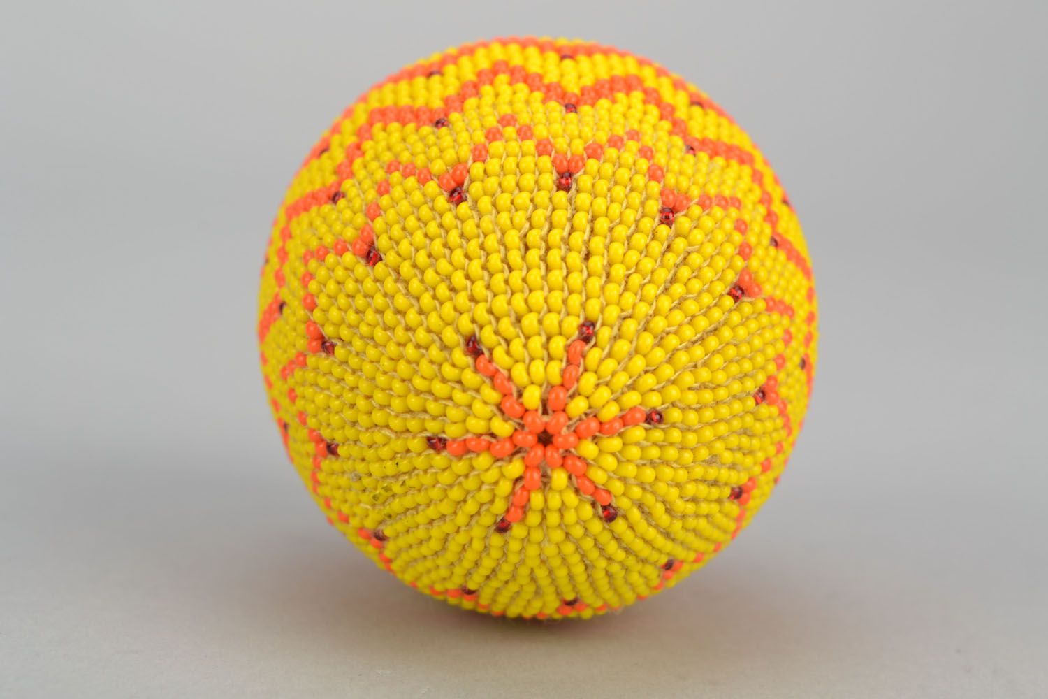 Wooden egg woven over with orange beads photo 3